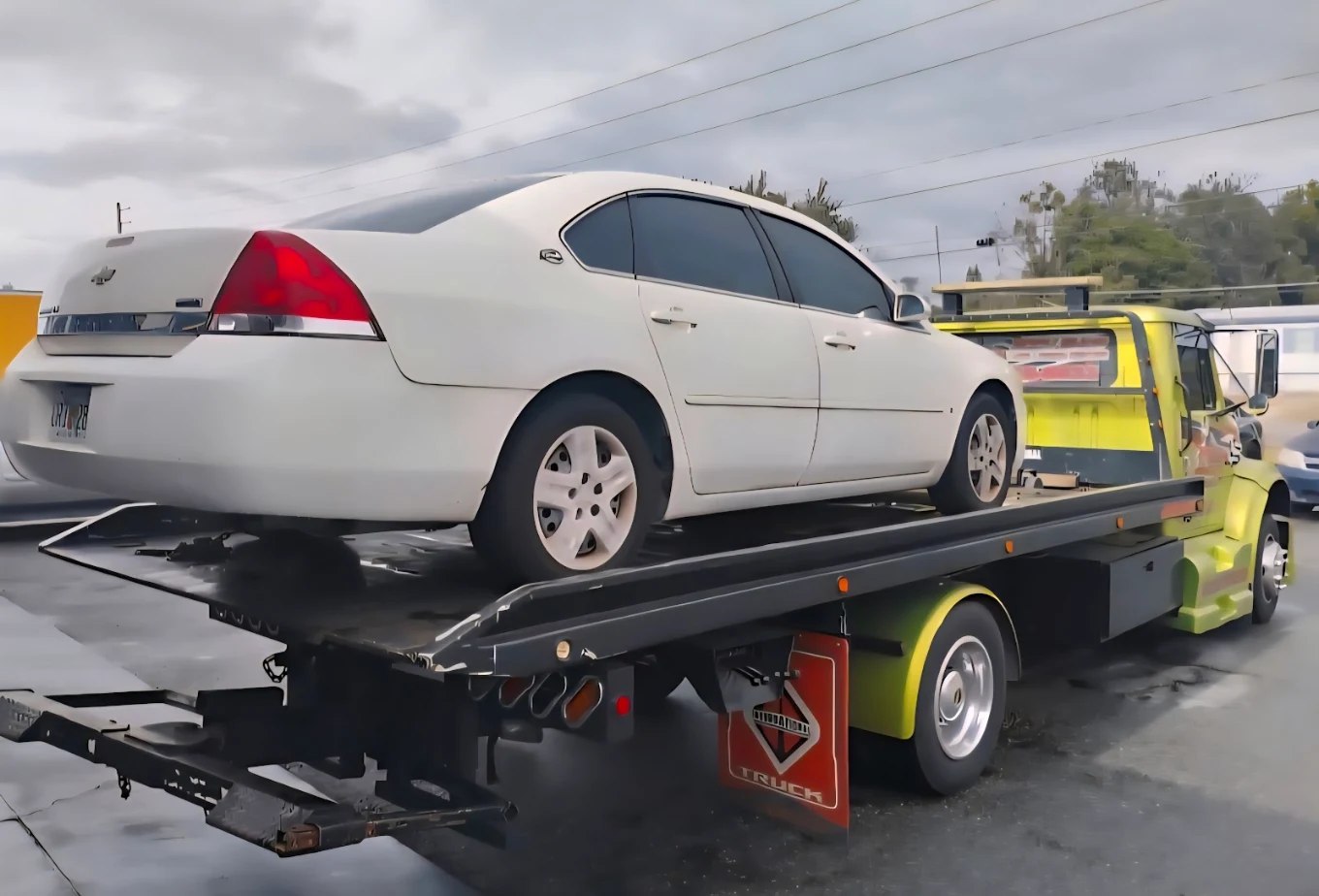 Reynoso flatbed tow truck loading a vehicle